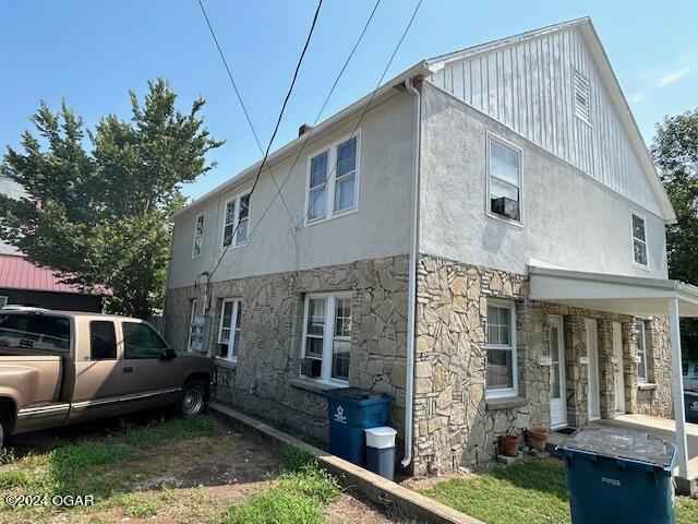 view of side of home with covered porch