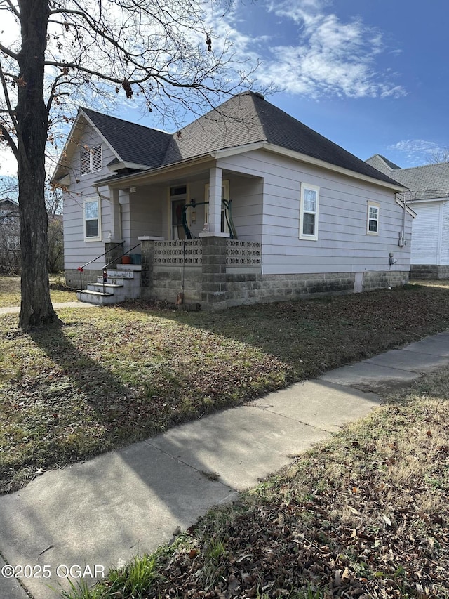 view of property exterior with a porch and a yard