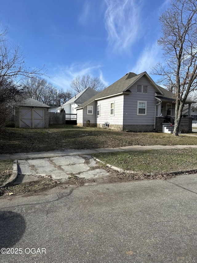 view of property exterior with a storage unit