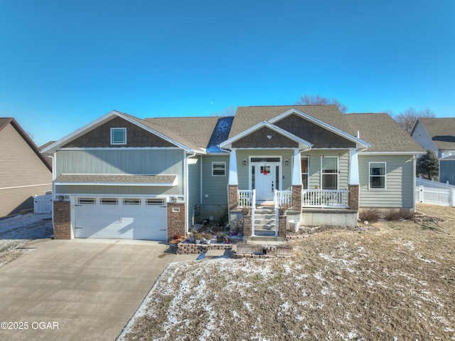 craftsman-style home featuring covered porch and a garage