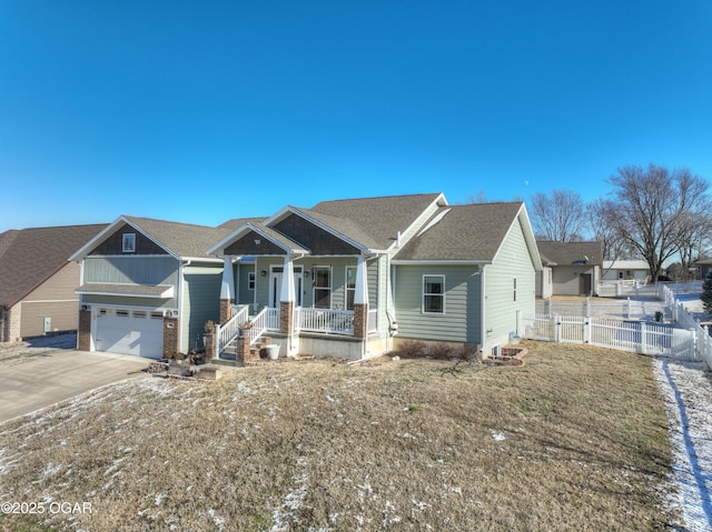 view of front of home with a porch, a garage, and a front yard