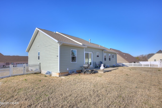 rear view of property featuring a patio and a lawn