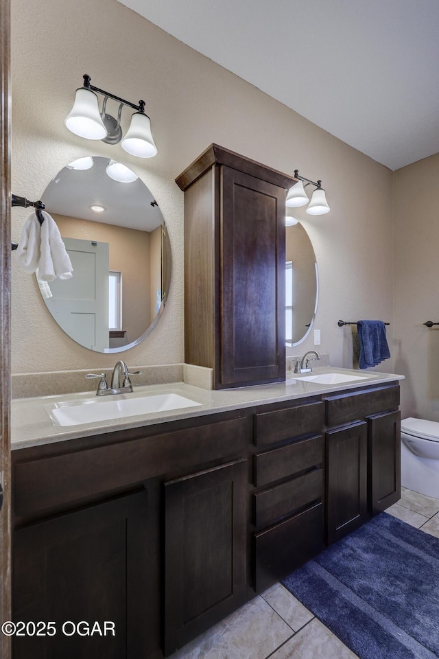 bathroom with tile patterned floors, vanity, and toilet