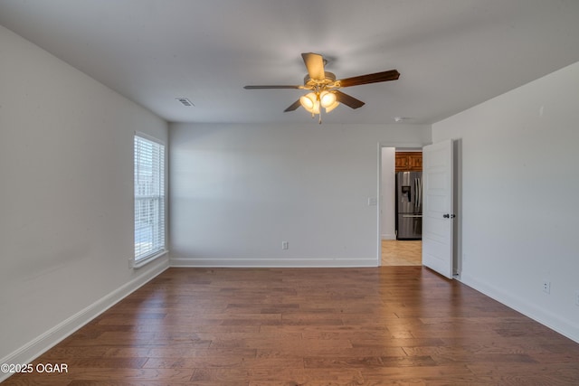 spare room with hardwood / wood-style floors and ceiling fan