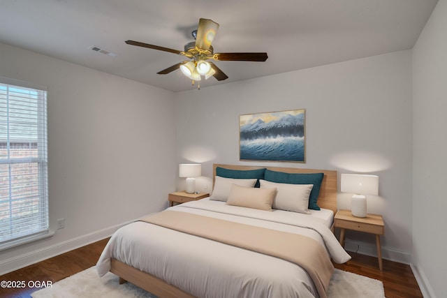 bedroom featuring ceiling fan and dark hardwood / wood-style floors