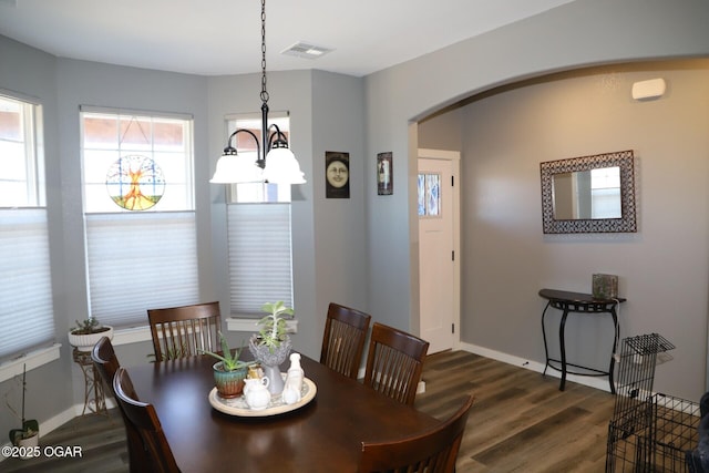 dining room featuring a chandelier and dark hardwood / wood-style floors