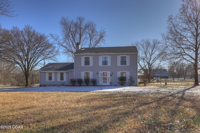 colonial home with a front yard