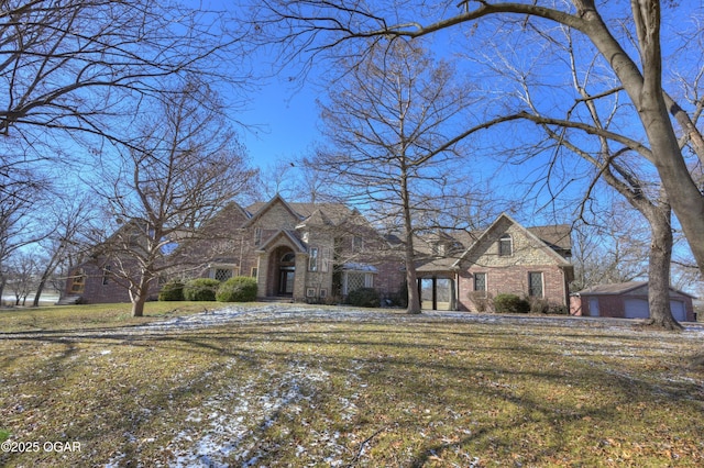 english style home with a front yard