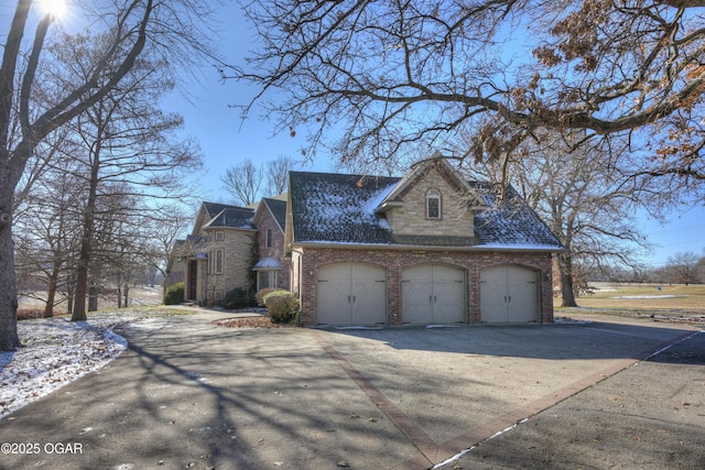 view of side of home featuring a garage