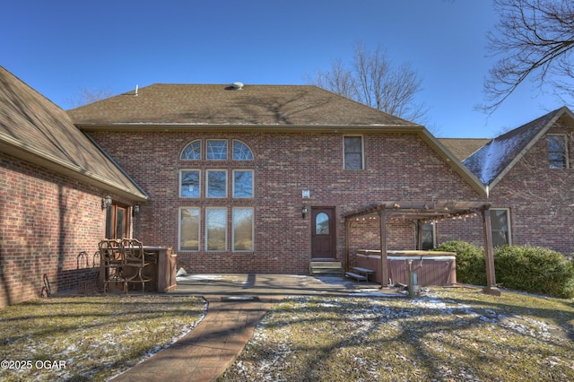 back of house with a patio and a hot tub