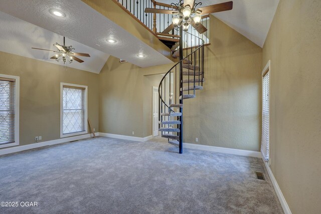 unfurnished living room featuring carpet flooring, a textured ceiling, high vaulted ceiling, and ceiling fan