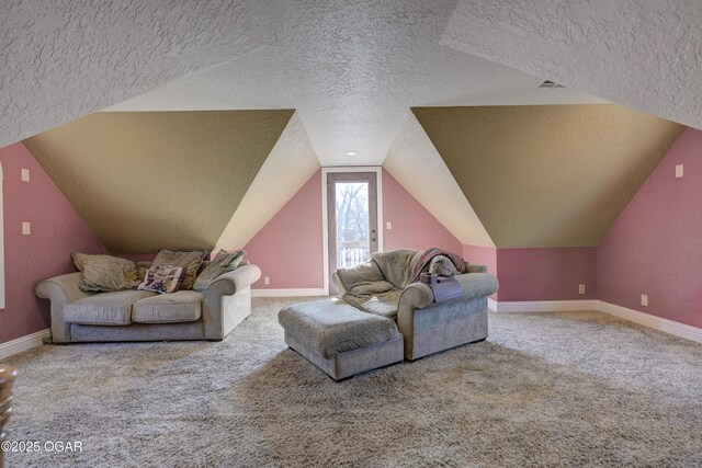 carpeted living room featuring lofted ceiling and a textured ceiling