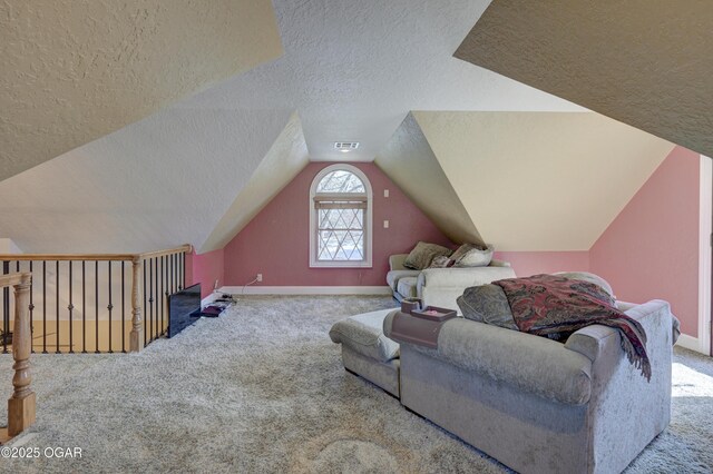 living room with light colored carpet, a textured ceiling, and vaulted ceiling