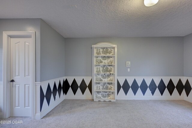 interior space with carpet and a textured ceiling