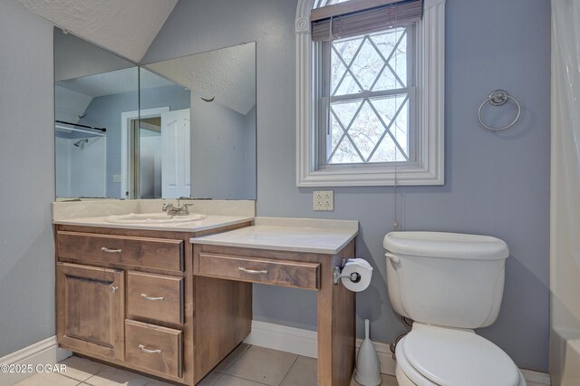 bathroom featuring vanity, tile patterned flooring, toilet, a textured ceiling, and walk in shower