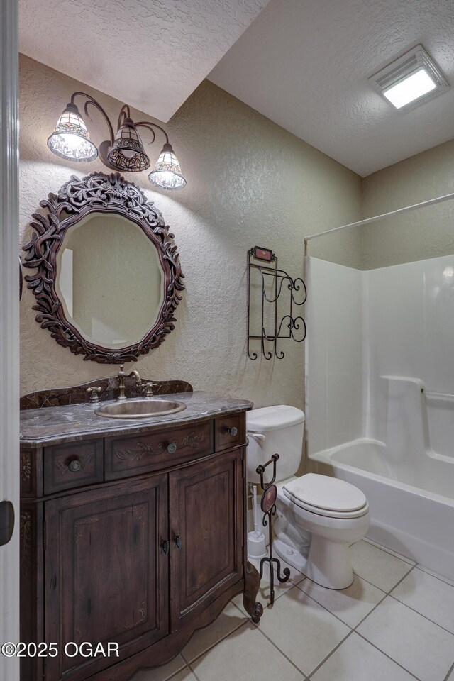 full bathroom with tile patterned floors, vanity, a textured ceiling, bathing tub / shower combination, and toilet