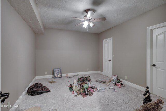 interior space with a textured ceiling and ceiling fan