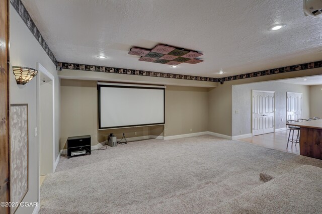 carpeted cinema featuring a textured ceiling