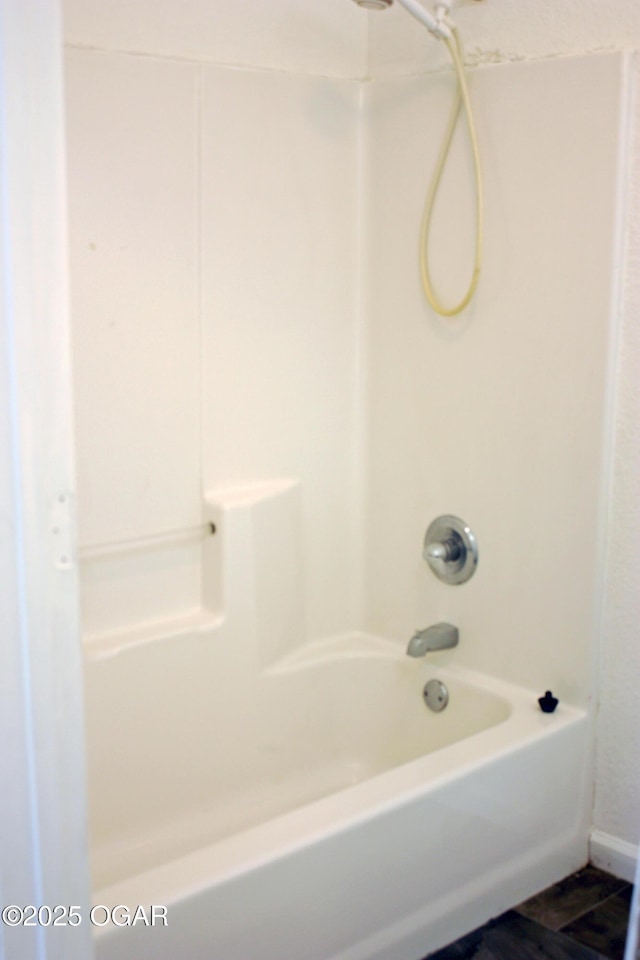 bathroom featuring tile patterned flooring and tub / shower combination