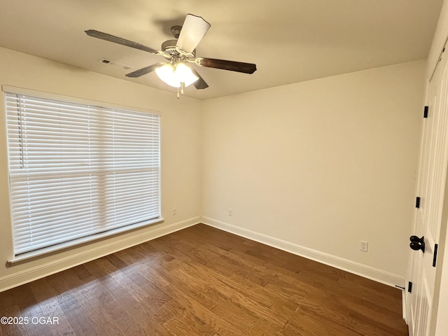 spare room featuring ceiling fan and dark hardwood / wood-style floors