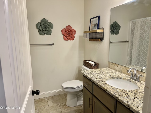 bathroom featuring toilet, vanity, and tile patterned flooring