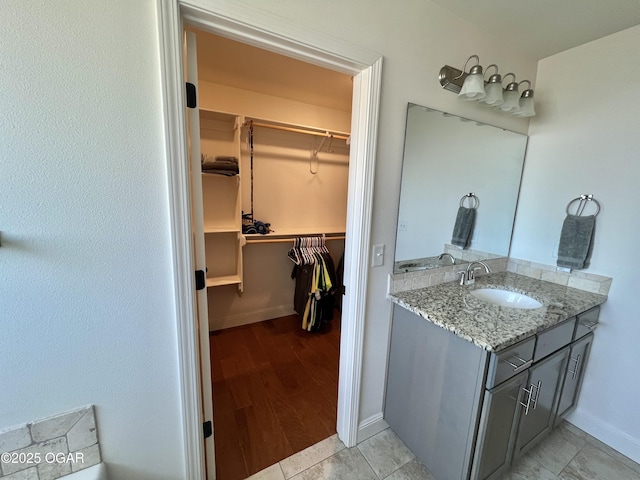 bathroom featuring tile patterned flooring and vanity