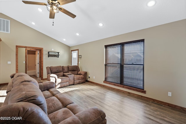 living room with ceiling fan, light hardwood / wood-style floors, and lofted ceiling