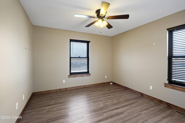 empty room featuring ceiling fan and hardwood / wood-style flooring