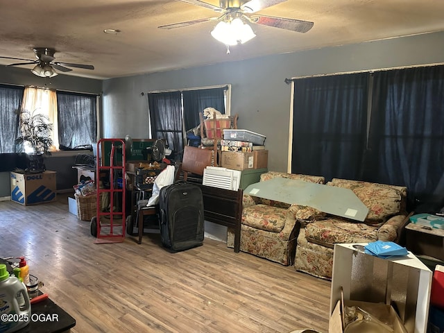 interior space with hardwood / wood-style floors and ceiling fan