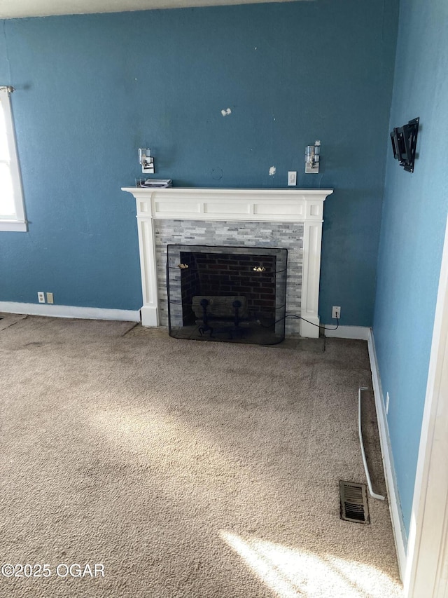 unfurnished living room with a fireplace and carpet floors