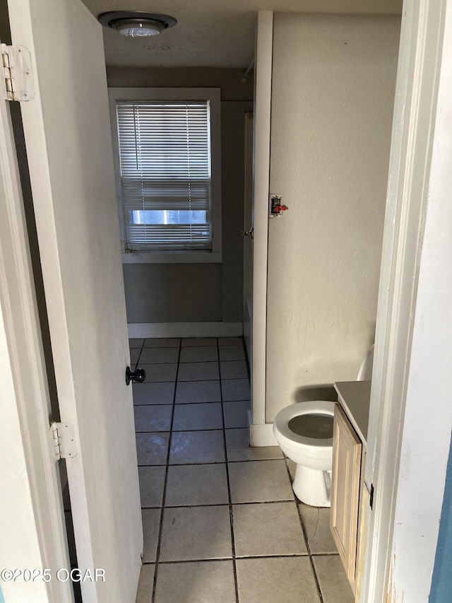 bathroom featuring toilet, vanity, and tile patterned floors