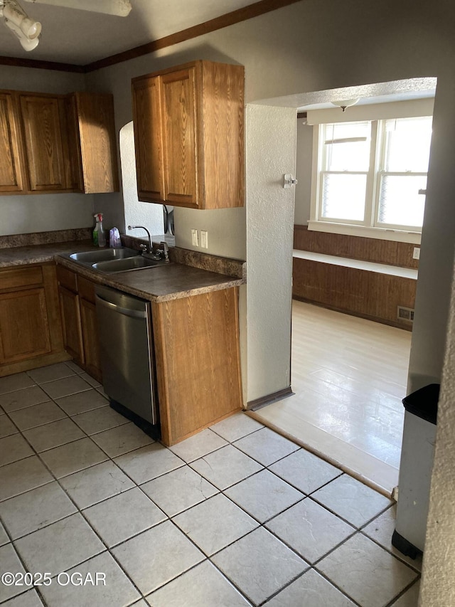 kitchen featuring dishwasher, light tile patterned floors, sink, and ornamental molding