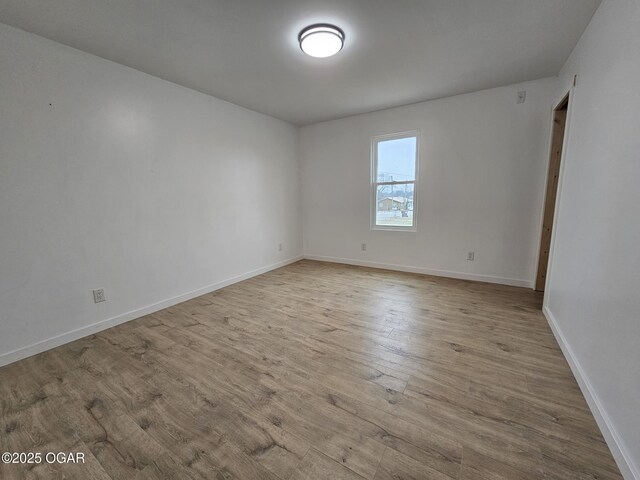 spare room featuring light hardwood / wood-style flooring