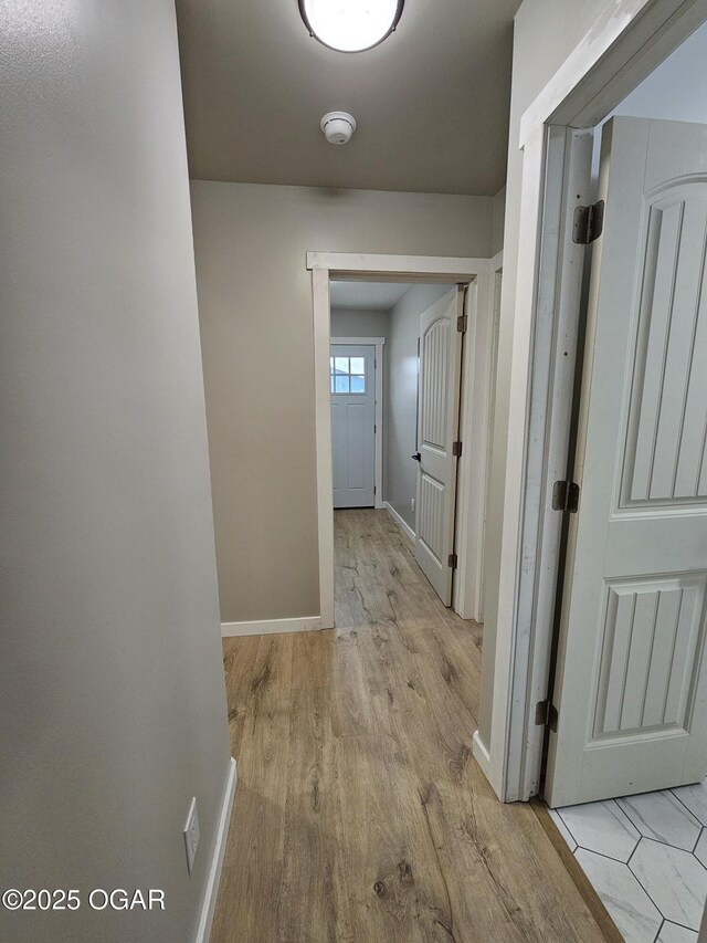 corridor with light hardwood / wood-style flooring