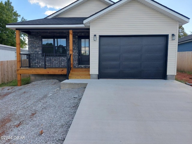 view of front of property with a porch and a garage