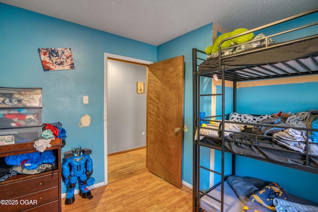 bedroom with wood-type flooring and a textured ceiling