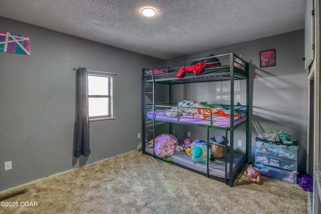 carpeted bedroom featuring a textured ceiling