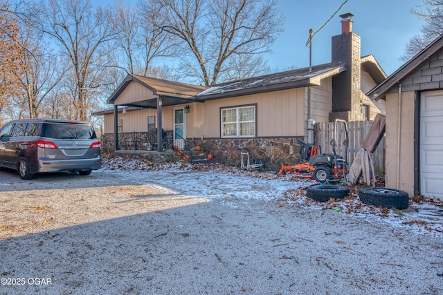 single story home with a porch and a garage