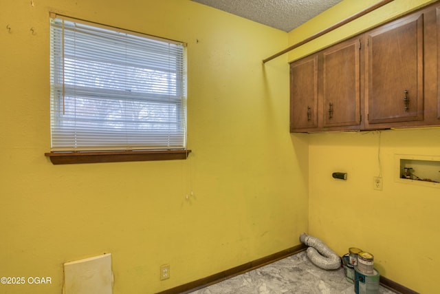 washroom featuring cabinets, a textured ceiling, hookup for a washing machine, electric dryer hookup, and light colored carpet