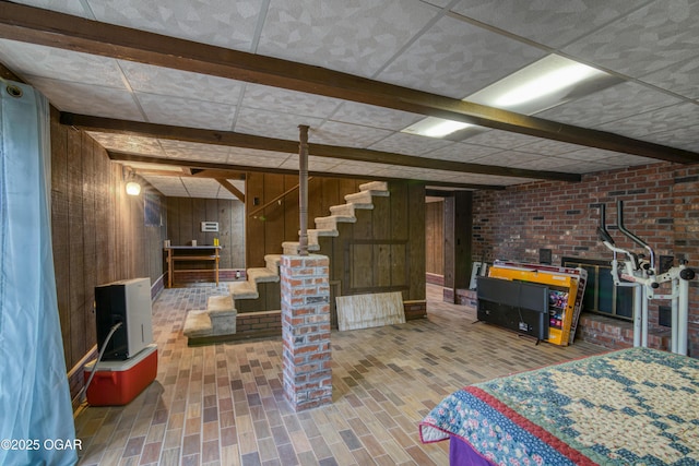 basement featuring wooden walls