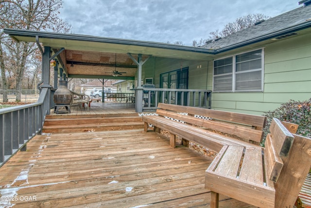 wooden terrace featuring ceiling fan