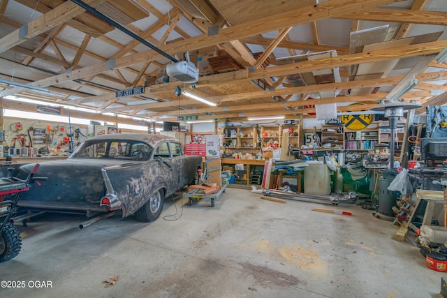 garage featuring a garage door opener and a workshop area