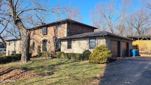 view of front of home with a garage and a front lawn