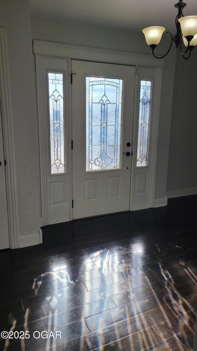 foyer featuring a chandelier