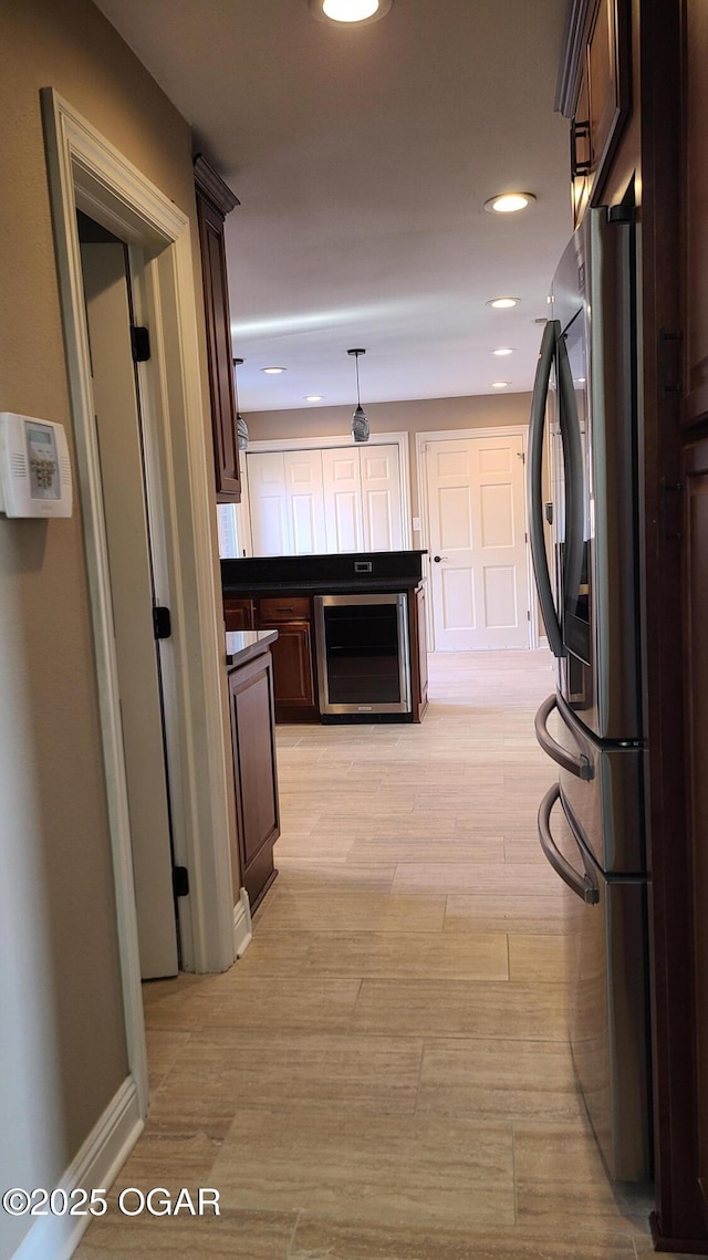 hall with wine cooler and light wood-type flooring