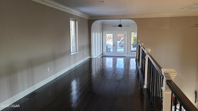 interior space with dark hardwood / wood-style flooring, crown molding, and french doors