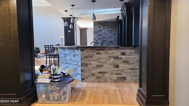 bar with pendant lighting and wood-type flooring