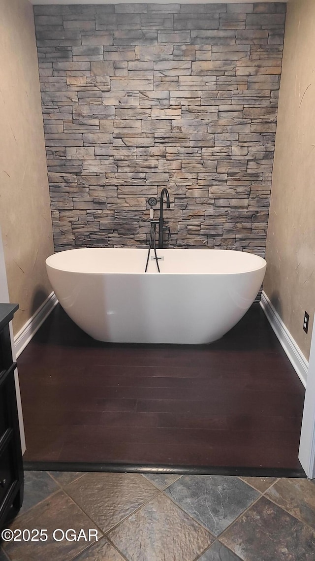 bathroom with vanity and a tub