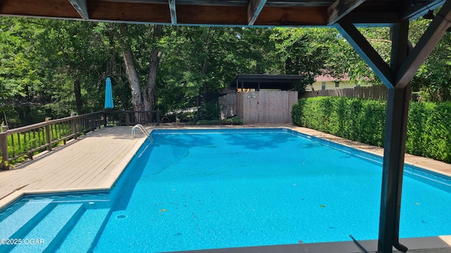 2007 E 47th St, Joplin, MO 64804 - view of swimming pool featuring a fenced backyard and a wooden deck