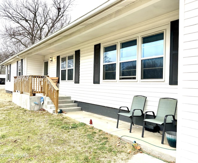 exterior space featuring a porch and a lawn